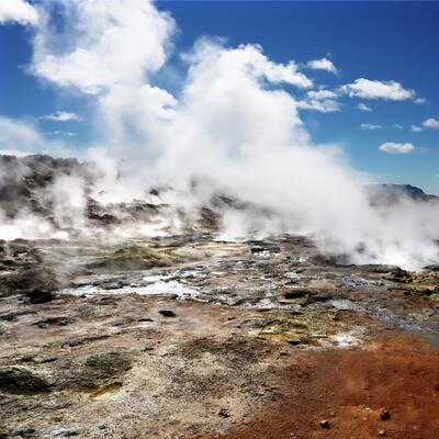 Image of steam rising over geothermal field