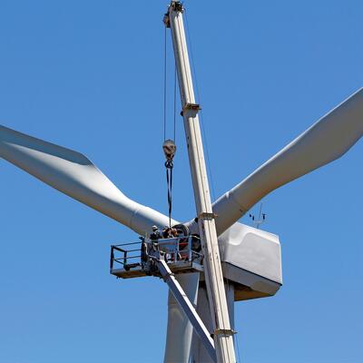 Maitenance workers repair a wind turbine